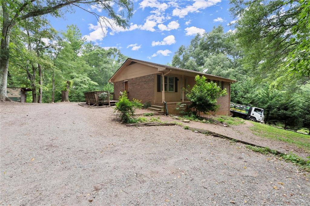 a backyard of a house with plants and trees