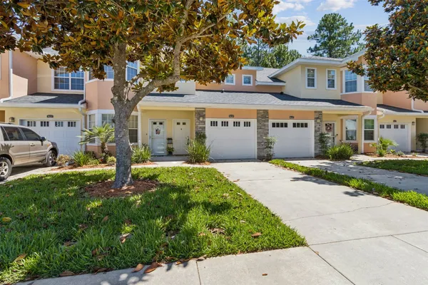 a front view of a house with a garden and yard