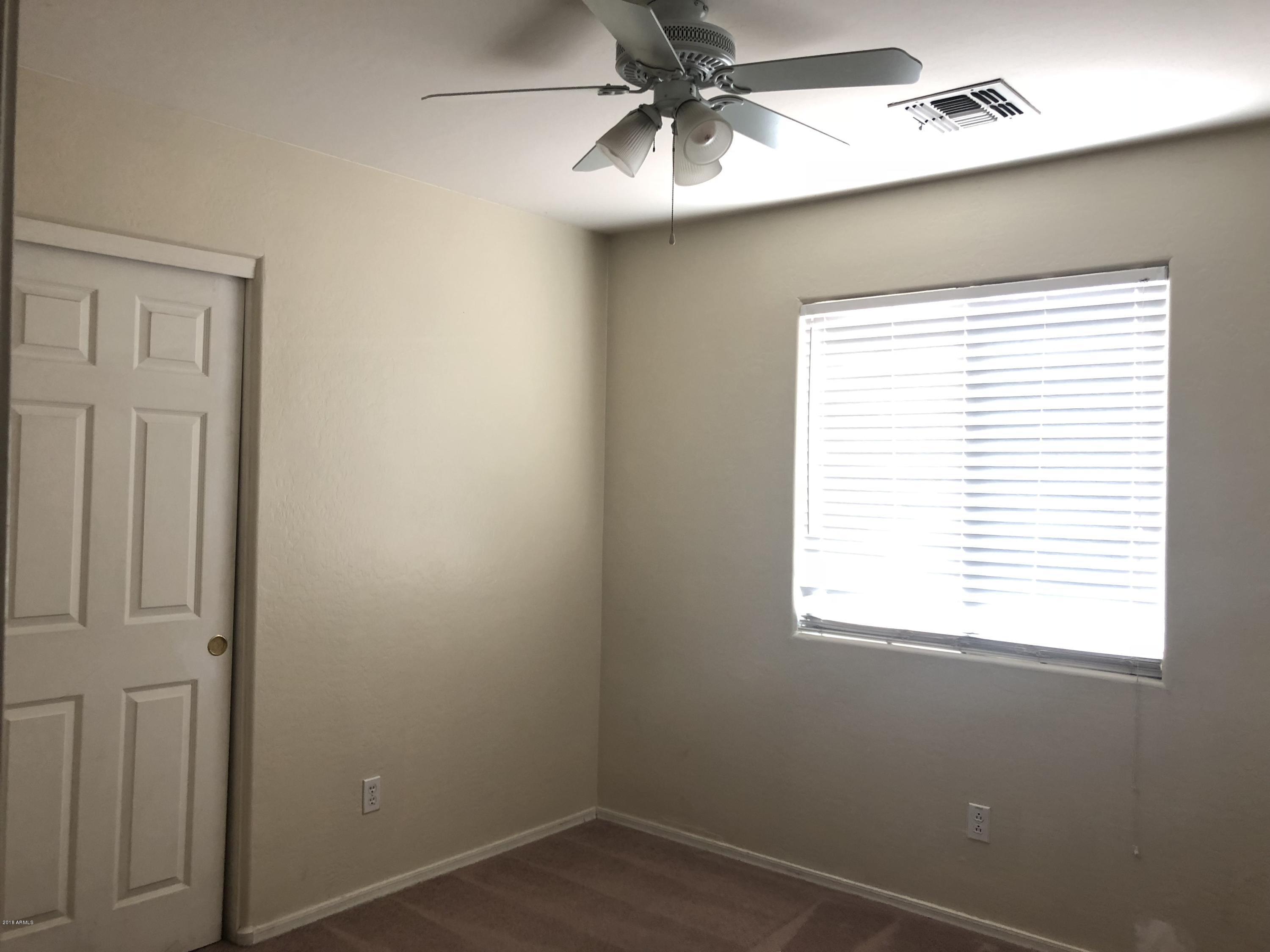 2321 West Maldonado Road Phoenix, AZ 85041 - Photo 20 of 44 an empty room with a window