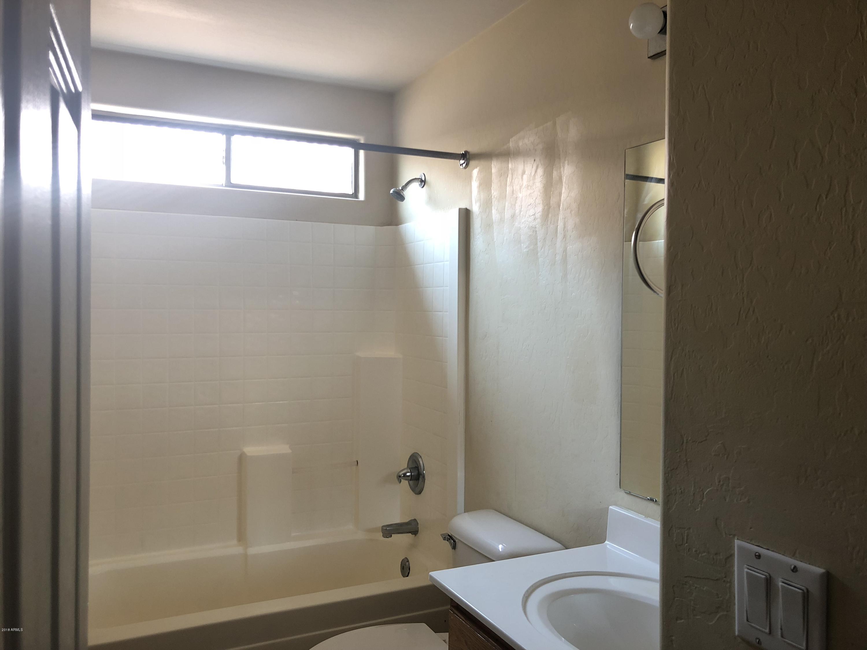 2321 West Maldonado Road Phoenix, AZ 85041 - Photo 22 of 44 a bathroom with a shower and a toilet