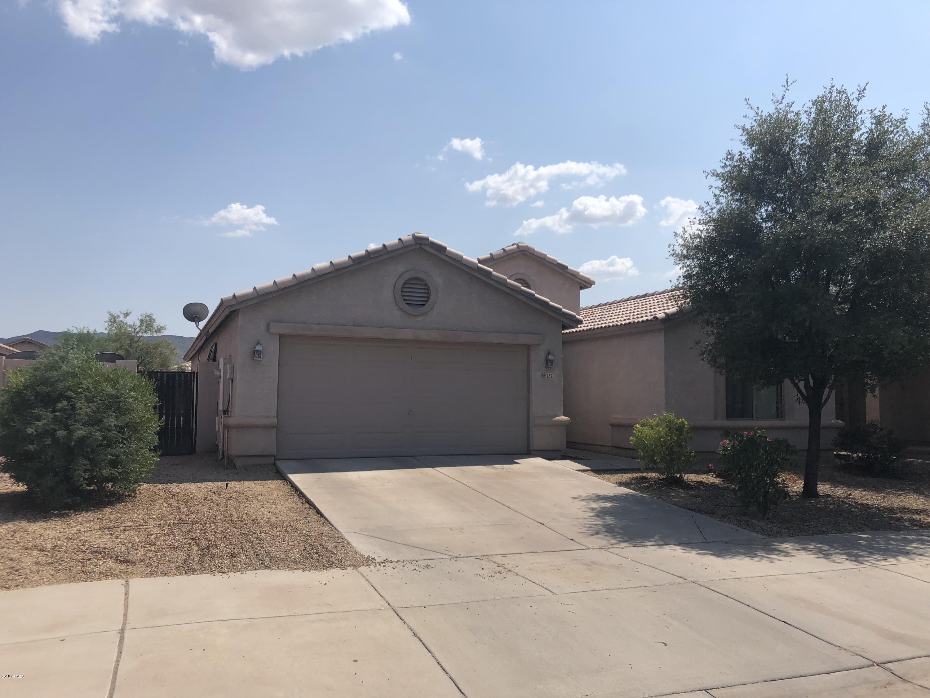 2321 West Maldonado Road Phoenix, AZ 85041 - Photo 3 of 44 a front view of a house with a yard and garage