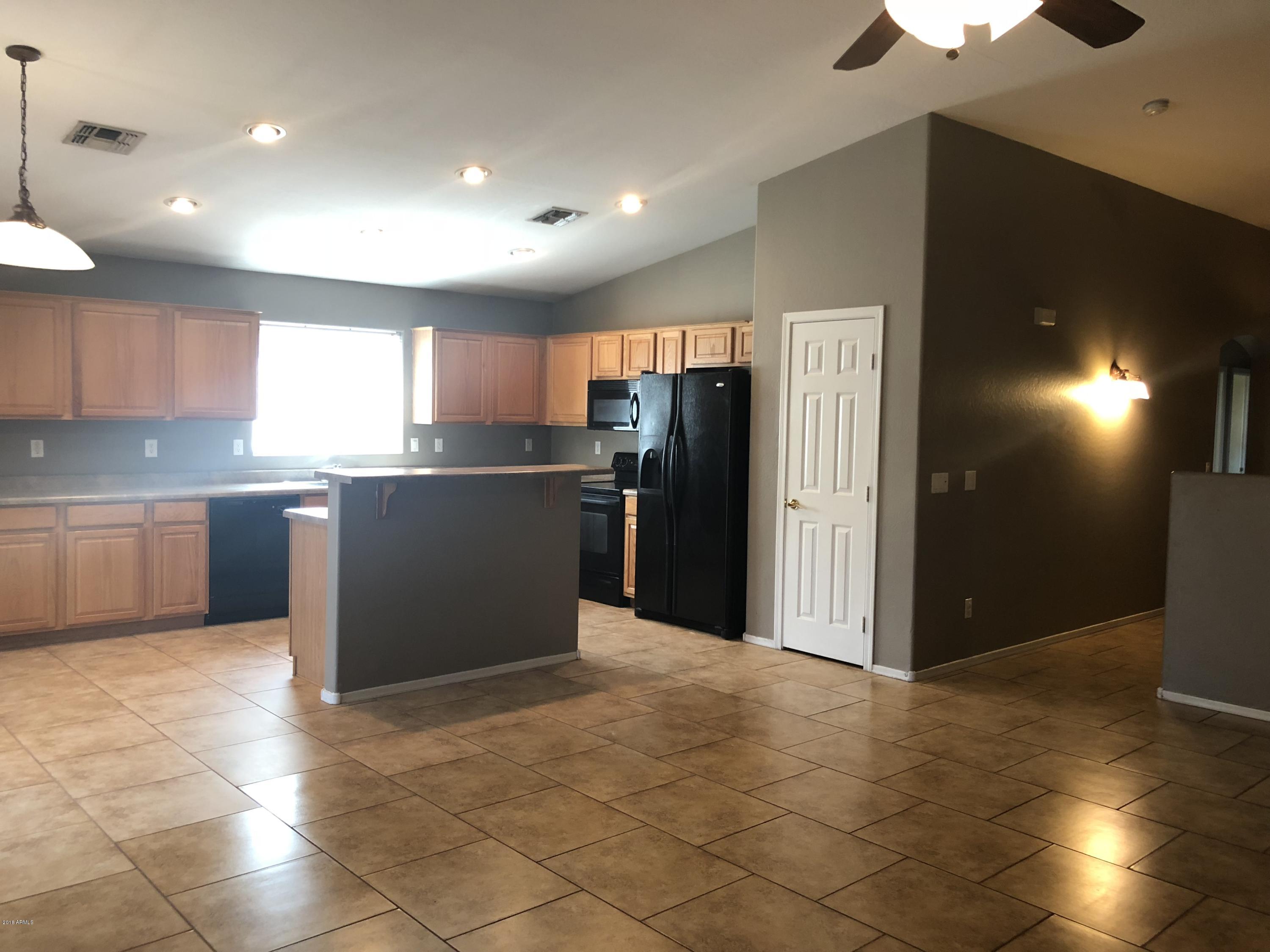 2321 West Maldonado Road Phoenix, AZ 85041 - Photo 9 of 44 a kitchen with stainless steel appliances granite countertop a refrigerator and a sink