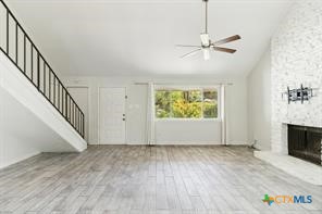 12011 Scribe Drive Austin, TX 78759 - Photo 3 of 14 a view of an empty room with wooden floor and a window