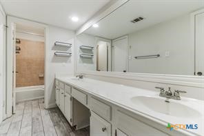 12011 Scribe Drive Austin, TX 78759 - Photo 8 of 14 a bathroom with a tub sink and mirror