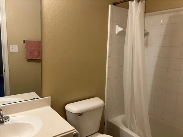 a bathroom with a bathtub and a toilet