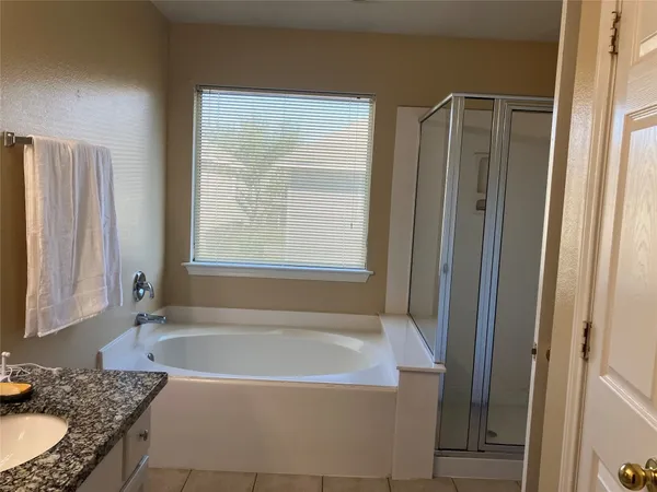 a bathroom with a glass shower door