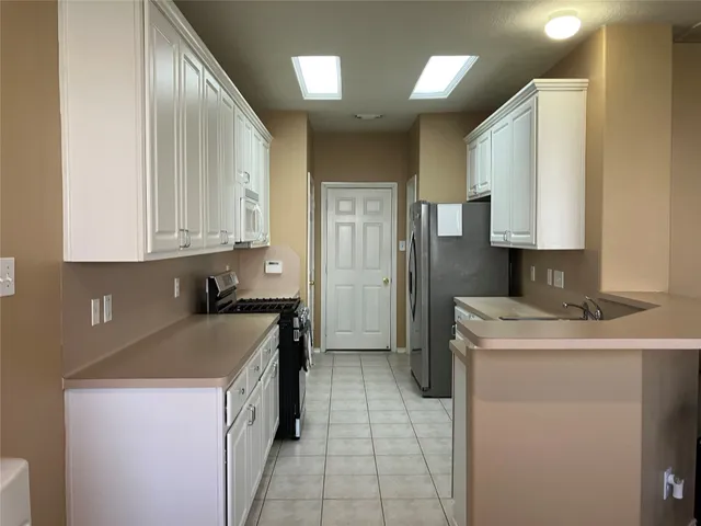 a kitchen with a sink stove and refrigerator