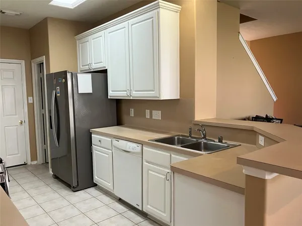 a kitchen with a sink and a refrigerator