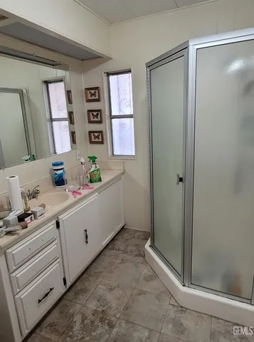a bathroom with a sink a mirror and a shower