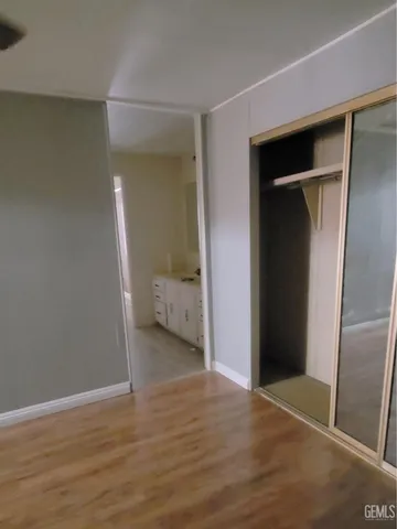 a view of a room with wooden floor and closet