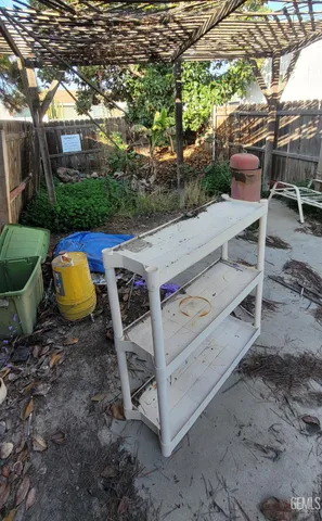 a view of a backyard with chairs and a fire pit