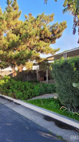 a view of a garden with a building in the background