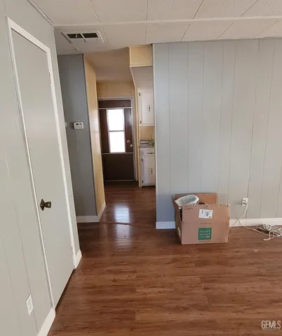a view of a hallway with wooden floor and closet