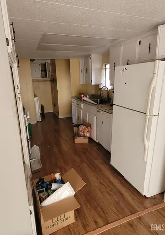 a white refrigerator freezer sitting inside of a kitchen