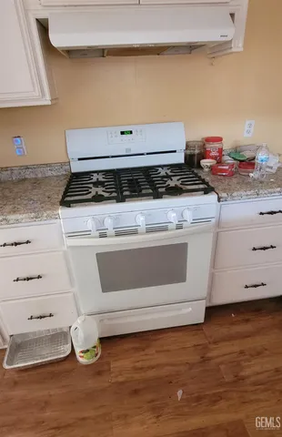 a stove top oven sitting inside of a kitchen