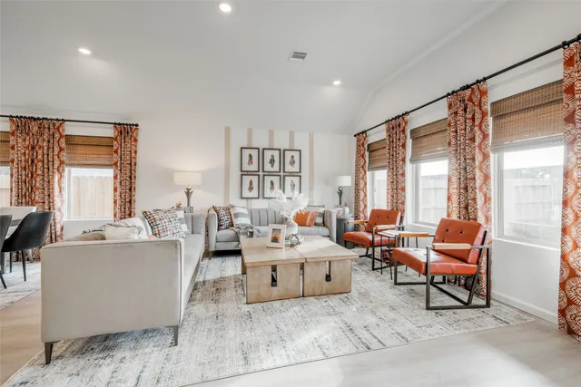 a view of a kitchen with kitchen island stainless steel appliances a table and chairs in it