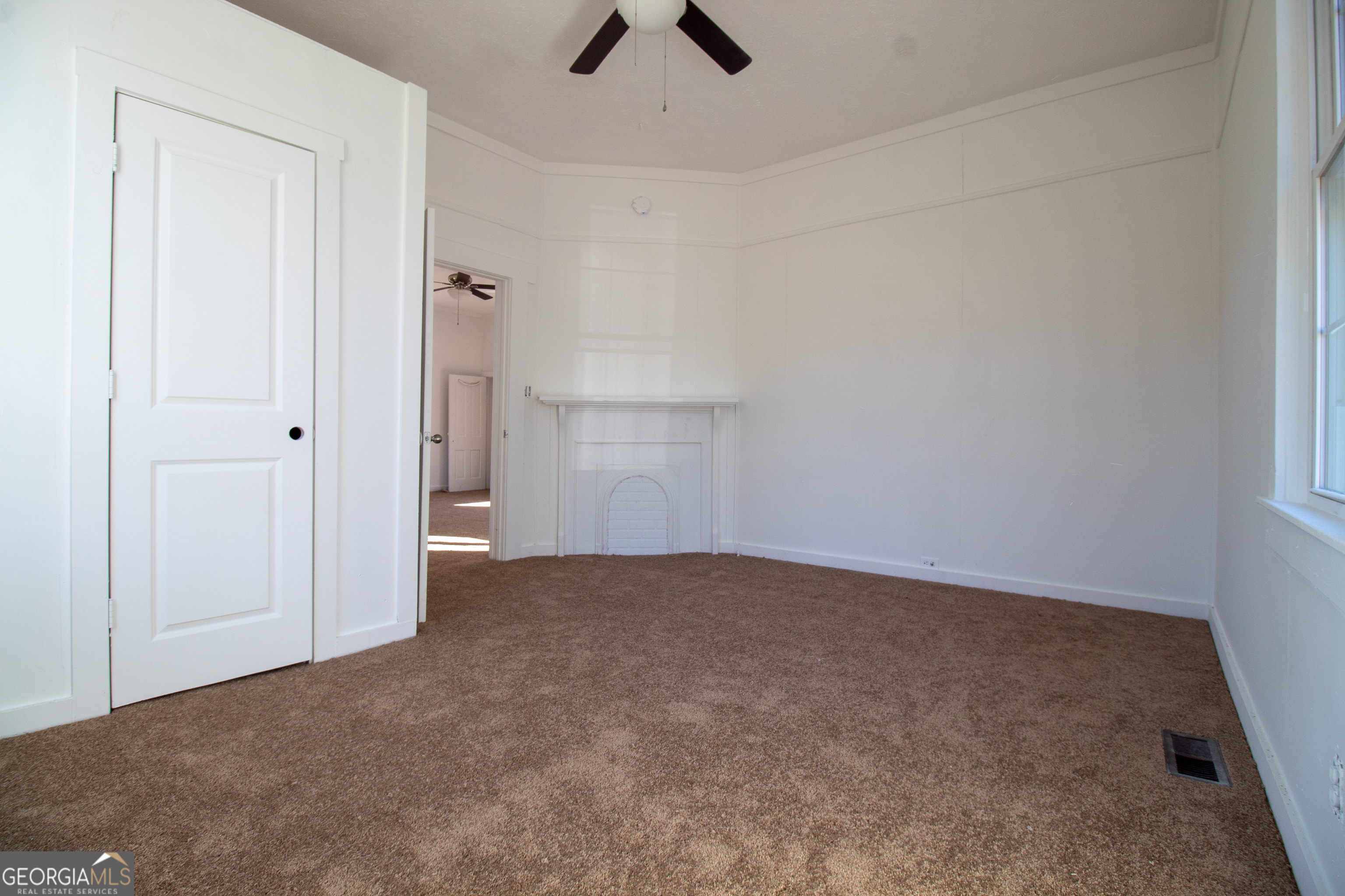 2 Wilson Street Manchester, GA 31816 - Photo 2 of 13 an empty room with ceiling fan and window