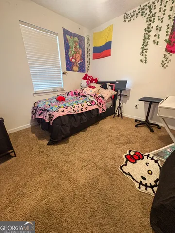 a bedroom with a bed and dresser