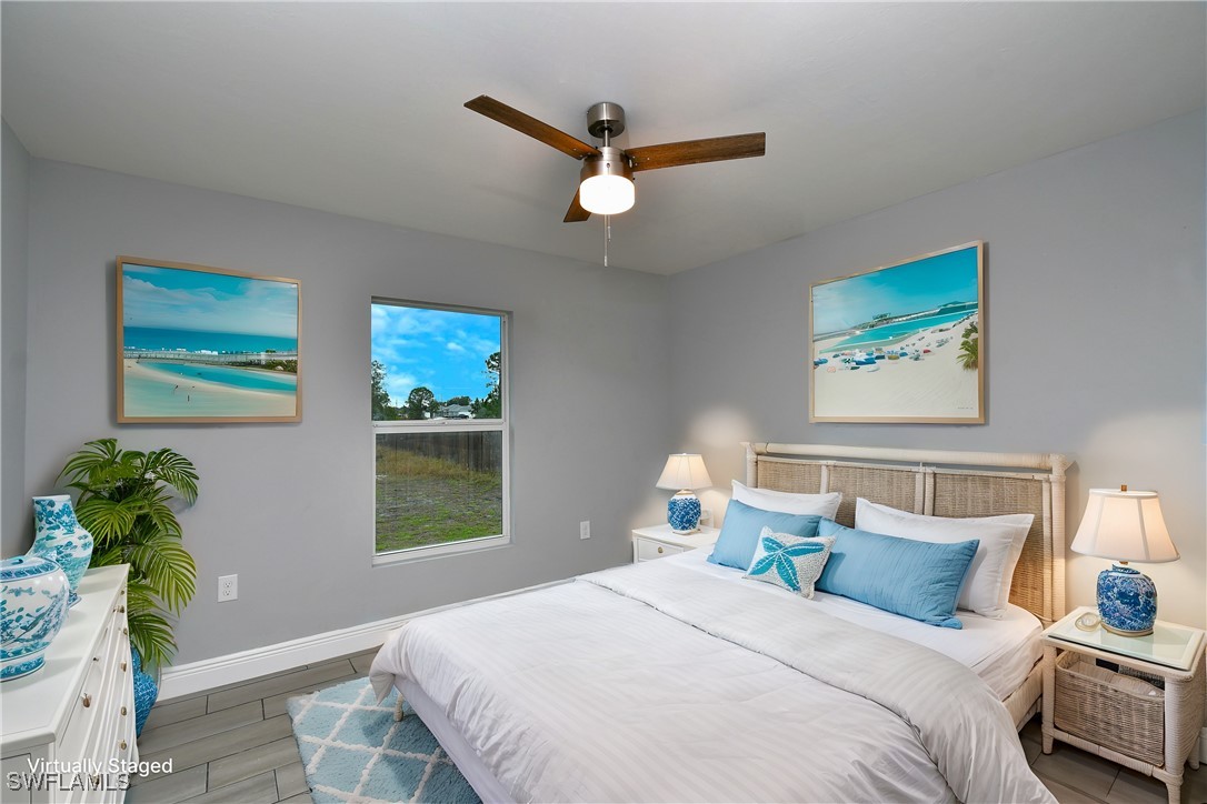 3103 Vera Avenue South Lehigh Acres, FL 33976 - Photo 21 of 36 a bedroom with a bed and a window
