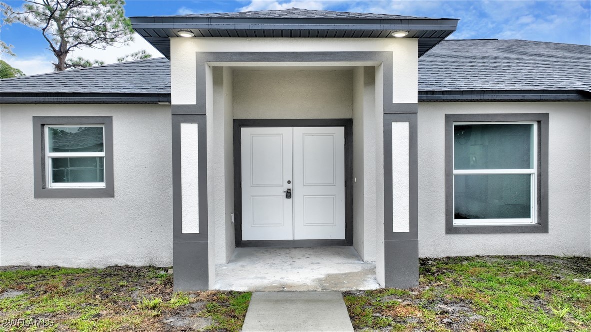 3103 Vera Avenue South Lehigh Acres, FL 33976 - Photo 4 of 36 a front view of a house with garden