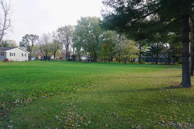 a view of a field of grass and trees