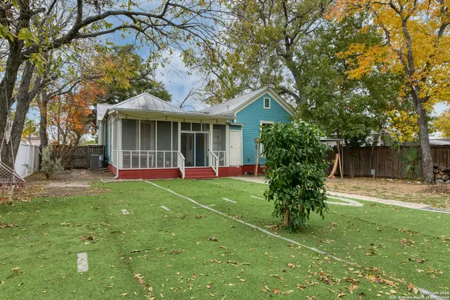 a backyard of a house with yard table and chairs