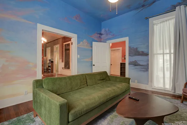 a living room with furniture and a chandelier