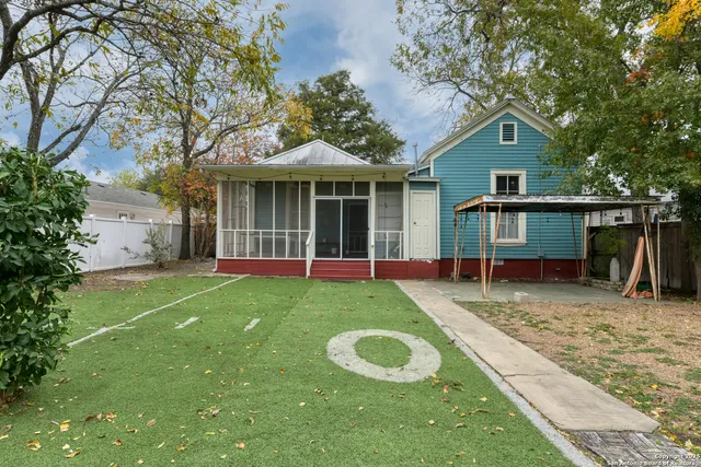 a view of a house with a yard and sitting area