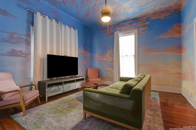 a living room with furniture and a flat screen tv