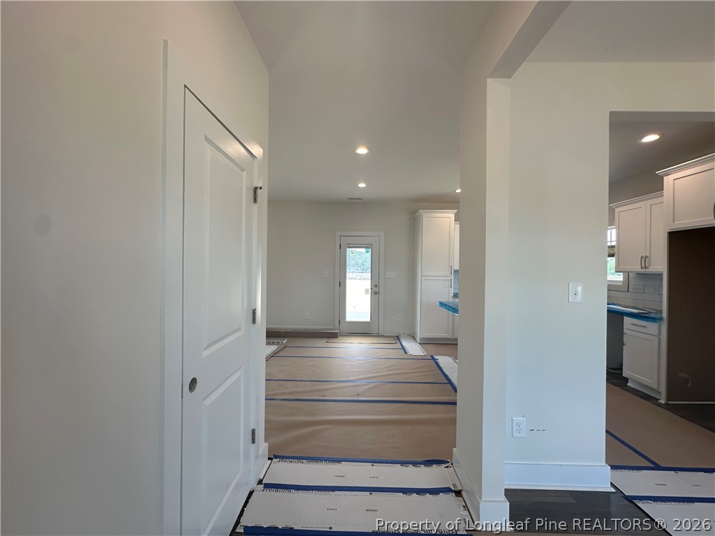 8383 Shannon Road Shannon, NC 28386 - Photo 2 of 17 a view of a hallway with wooden floor and staircase