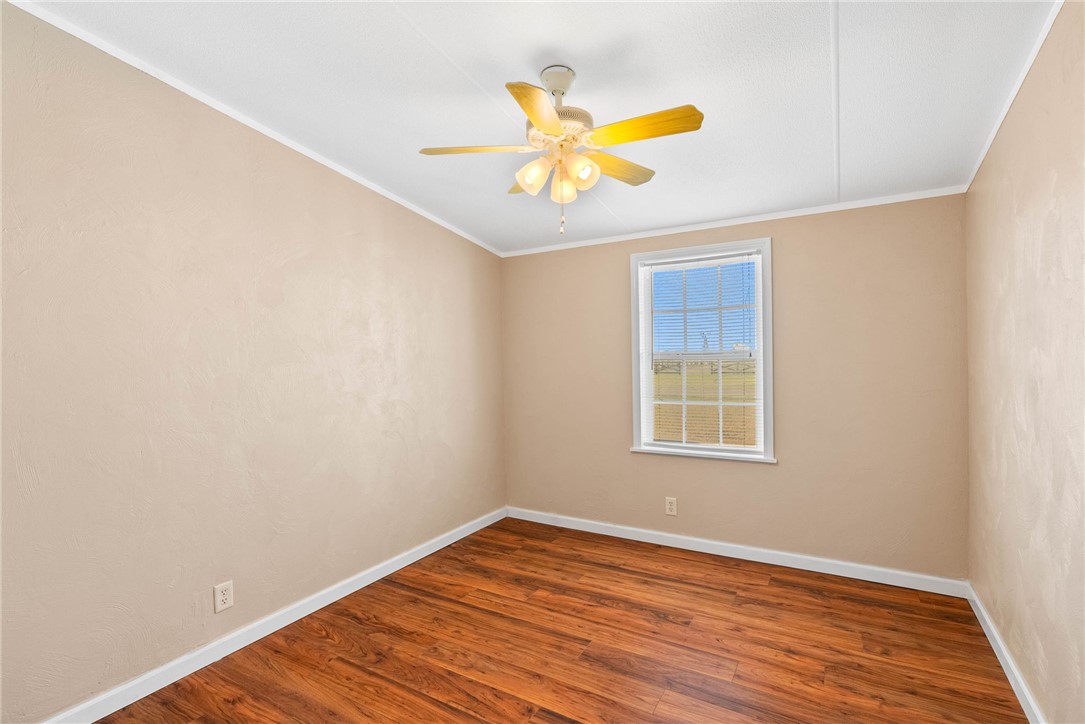 4752 Homestead Lane Robstown, TX 78380 - Photo 11 of 22 a view of an empty room with wooden floor and a window