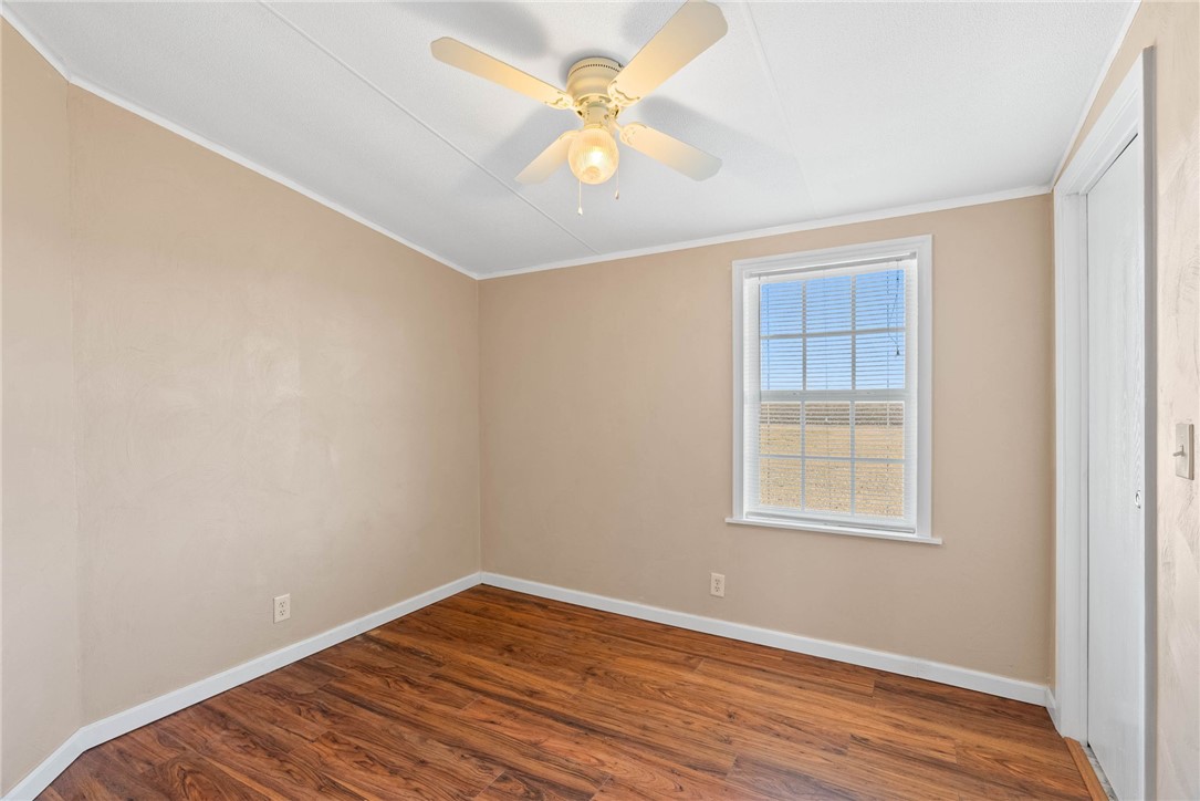 4752 Homestead Lane Robstown, TX 78380 - Photo 12 of 22 wooden floor in an empty room with a window
