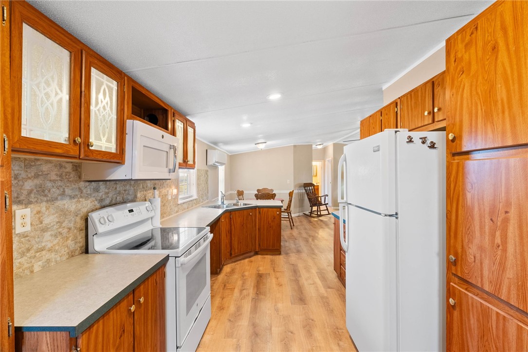 4752 Homestead Lane Robstown, TX 78380 - Photo 5 of 22 a kitchen with a refrigerator a stove and a microwave oven
