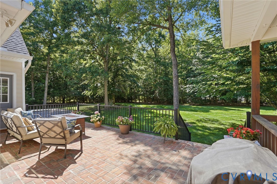 12123 Deer Ridge Court Ashland, VA 23005 - Photo 56 of 63 a view of a patio with a table chairs and a backyard