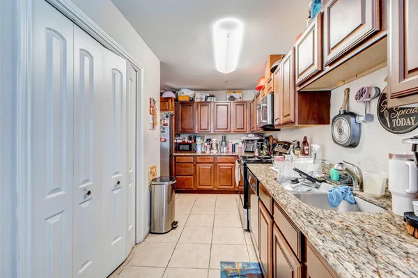 a kitchen with stainless steel appliances granite countertop a sink and cabinets