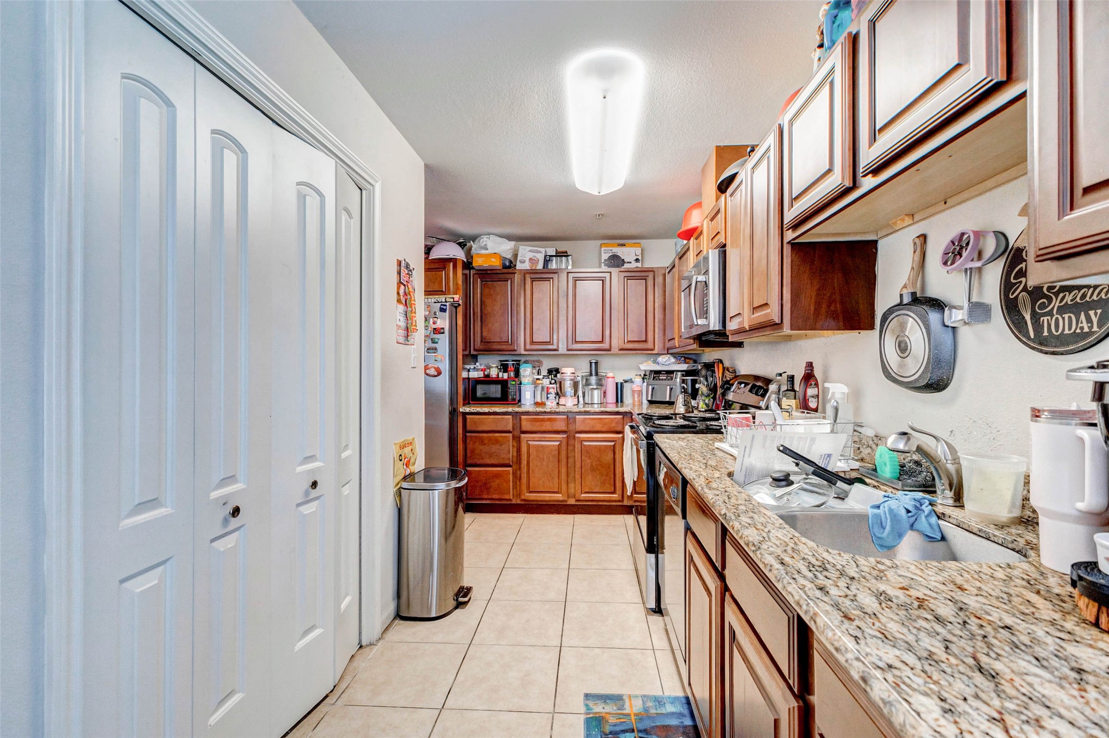 1702 Doyle Court, Unit 2 Pasadena, TX 77503 - Photo 17 of 30 a kitchen with stainless steel appliances granite countertop a sink and cabinets