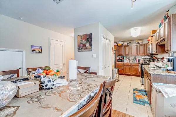 a living room filled with furniture and a dining table