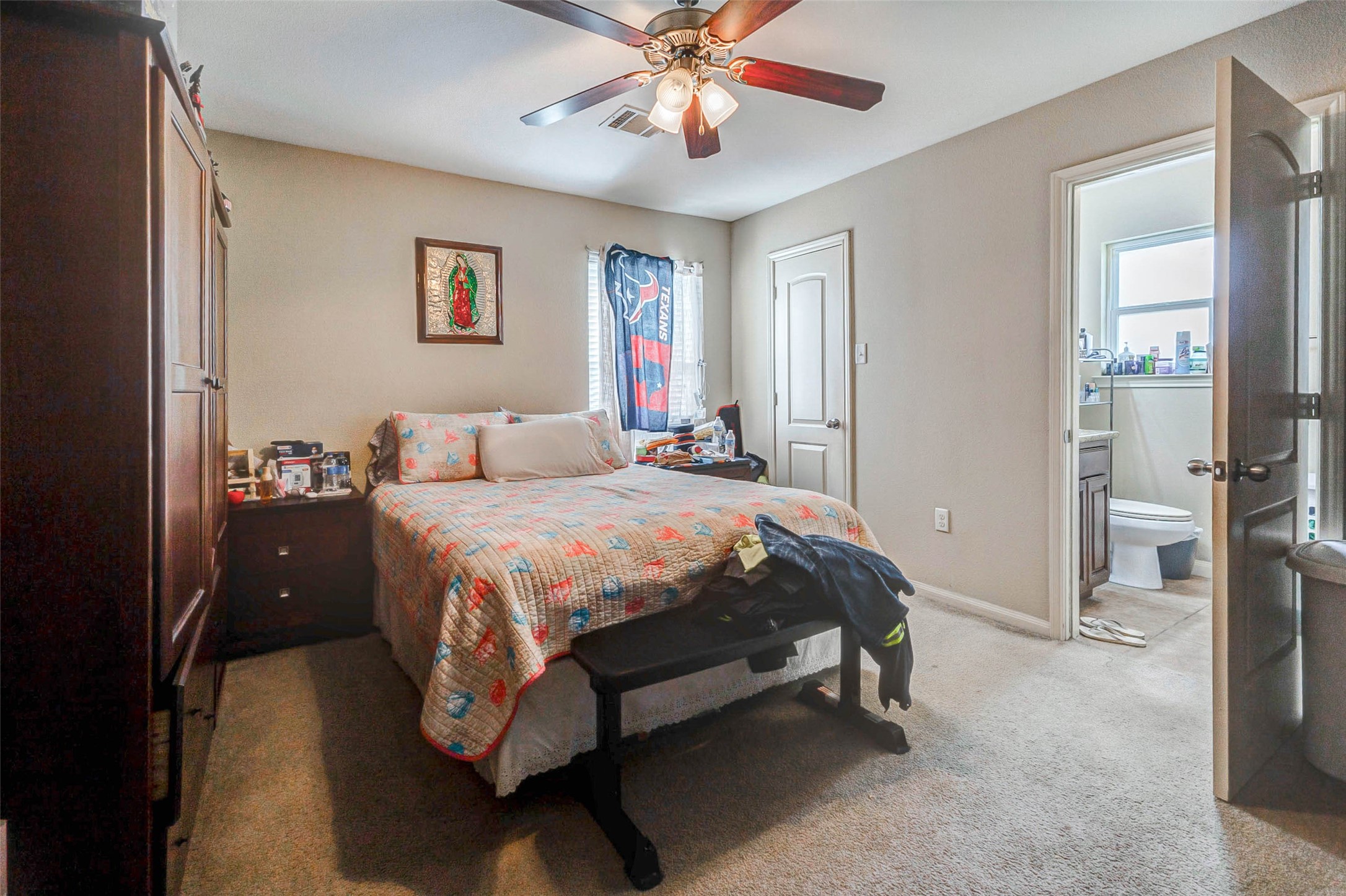 1702 Doyle Court, Unit 2 Pasadena, TX 77503 - Photo 21 of 30 a spacious bedroom with a bed and a chandelier