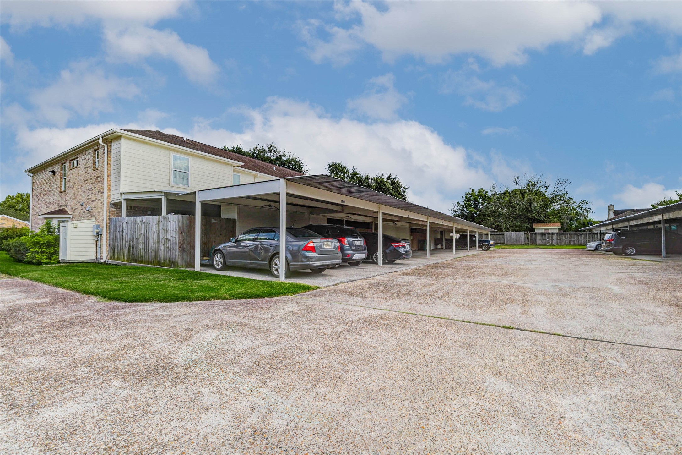 1702 Doyle Court, Unit 2 Pasadena, TX 77503 - Photo 28 of 30 a front view of a house with a garden and trees