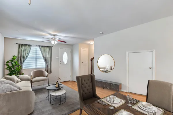 a living room with furniture a lamp and a large mirror