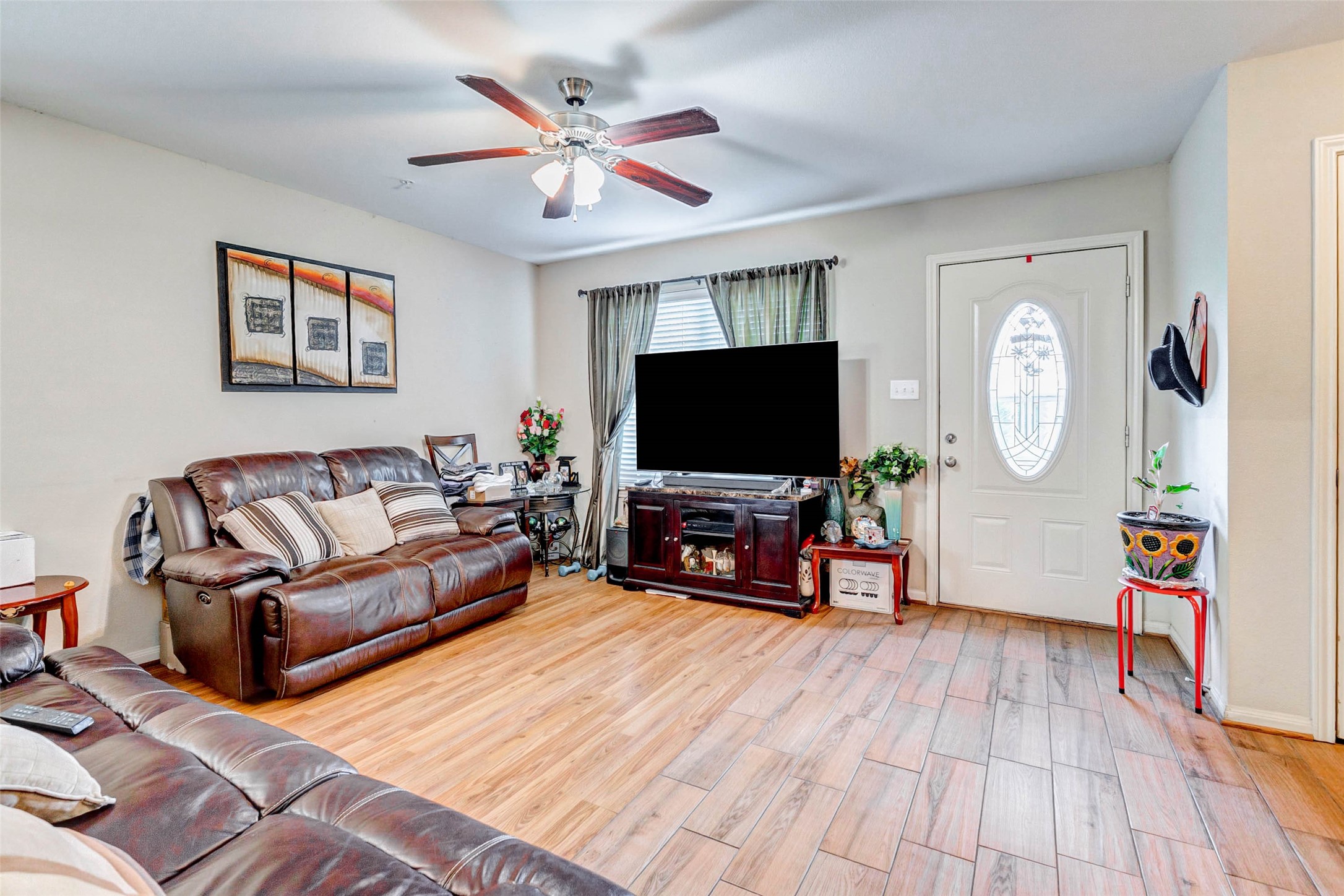 1702 Doyle Court, Unit 2 Pasadena, TX 77503 - Photo 9 of 30 a living room with furniture a flat screen tv and a large window