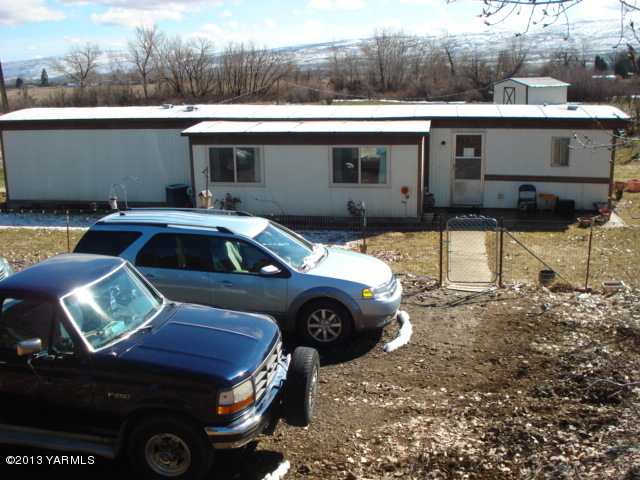 a front view of a house with parking space