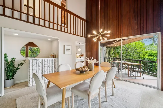 a kitchen with stainless steel appliances a sink and large window