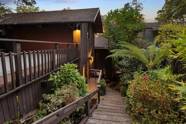 a balcony with wooden floor table and chairs