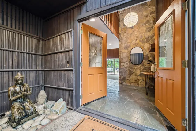 a living room with furniture a fireplace and a large window