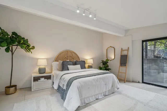 a view of a dining room with furniture large windows and wooden floor