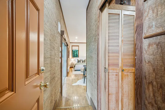 a bedroom with a large bed and a wooden floor