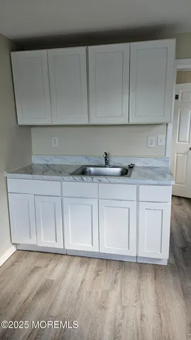 a kitchen with white cabinets
