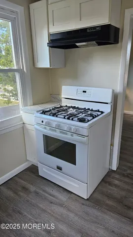 a stove top oven sitting inside of a kitchen