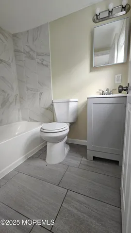 a bathroom with a toilet a sink and bathtub